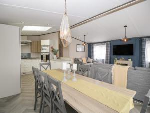 a kitchen and living room with a table and chairs at 14 Fairways in Burnham on Sea