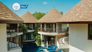 a house with a balcony overlooking the ocean at Bangsak Village - Adults Only - SHA Extra Plus in Khao Lak