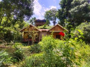 a house with a garden on top of it at Mountain View Cottages & Villa Tangkahan in Tangkahan