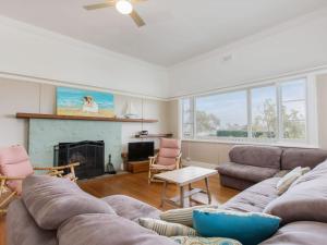 a living room with a couch and a fireplace at BEACHSIDE GETAWAY DROMANA in Dromana
