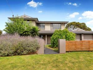 a house with a wooden fence in the yard at AMALFI - DROMANA.... in Dromana