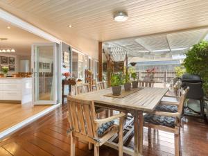 a dining room with a wooden table and chairs at Karinya Mornington in Mornington