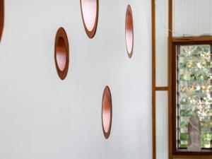 a group of mirrors hanging on a wall at LANAI HOUSE BALNARRING BEACH in Balnarring Beach