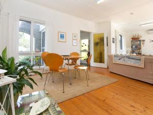 a living room with a table and chairs at Home Sweet Home Mount Martha in Mount Martha