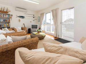 a living room with a couch and chairs and a tv at Home Sweet Home Mount Martha in Mount Martha