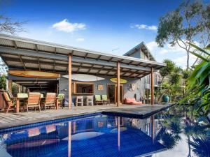 a house with a swimming pool and a patio at Point Leo Beach House Point Leo in Mount Martha