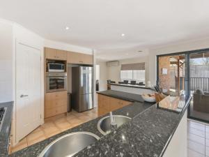 a kitchen with two sinks and a counter top at Sweetlands Sanctuary in Mount Martha