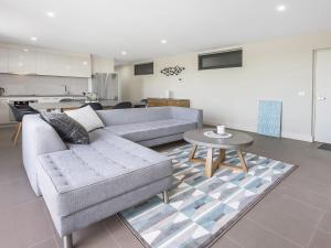 a living room with a couch and a table at Ocean Beach Retreat Sorrento in Sorrento