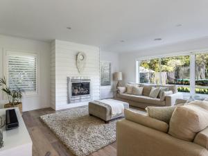 a living room with a couch and a fireplace at Allambea Mount Eliza in Mount Eliza