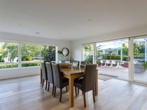 a dining room with a wooden table and chairs at Allambea Mount Eliza in Mount Eliza