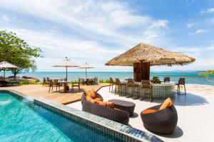 a resort with a pool and chairs and tables at Rocky's Boutique Resort - Veranda Collection Samui in Lamai