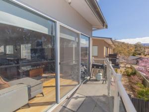 a balcony with sliding glass doors on a house at Aspect 1 8a Poley Cow Lane in Jindabyne