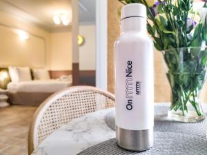 a white water bottle sitting on top of a table at Aparthotel AMMI Vieux Nice in Nice