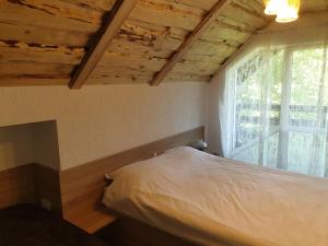 a small bedroom with a bed and a window at Casa Brândușa in Bran