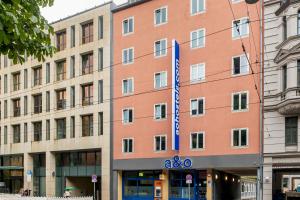 a building with a large sign on the front of it at a&o München Hauptbahnhof in Munich