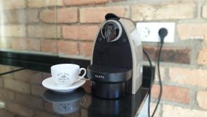 a coffee maker and a cup on a table at Casa Filomena apartamento de diseño en St. Joan de les Abadesses in Sant Joan de les Abadesses