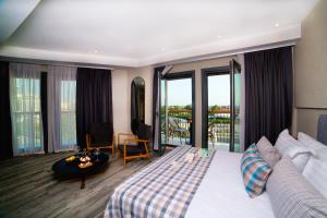 a hotel room with a bed and a balcony at Dosso Dossi Hotels Yenikapı in Istanbul