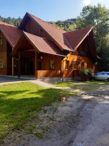 a large wooden house with a car parked in front at Schutzhaus Johannesbachklamm in Unterhöflein