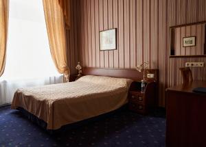 Cama ou camas em um quarto em Belvedere Nevsky Business Hotel