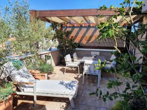 a patio with a table and chairs in a garden at Apartment Garden Terrace in Zadar