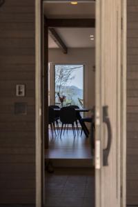 a view of a dining room with a table and chairs at Hakuba Kaede House in Hakuba