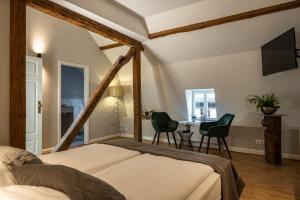 a bedroom with a bed and a table and chairs at Hotel zur Krone in Sankt Martin