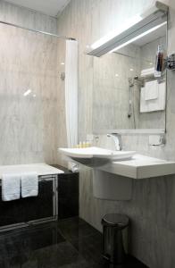 
a bathroom with a sink, toilet and shower at Belvedere Nevsky Business Hotel in Saint Petersburg
