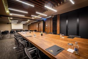 a large conference room with a long table and chairs at Amsterdam Hotel in Belgrade