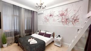 a bedroom with a bed and a brick wall at Inn Home Apartments-Olimpiysky Stadium area in Kyiv
