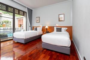 Ένα ή περισσότερα κρεβάτια σε δωμάτιο στο Plakan Resort