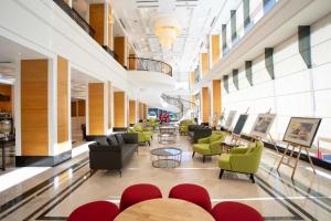 a lobby with chairs and tables in a building at Perdana Kota Bharu in Kota Bharu