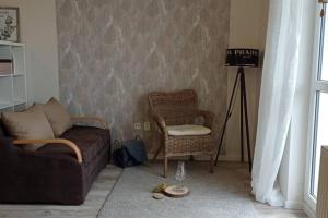 a living room with a couch and a chair at Apartmán Dvojka in Náchod