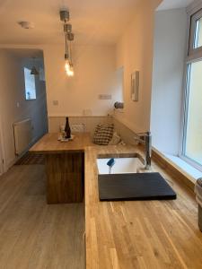 a kitchen with a sink and a counter top at Hobbes Cottage, pets allowed in Tenby +32 photos
