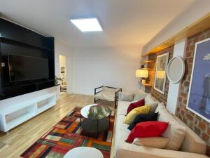 a living room with a couch and a flat screen tv at Bastion Apartament 4 in Timişoara