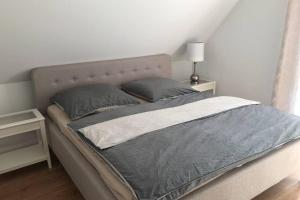 Postel nebo postele na pokoji v ubytování Leaf&Stay Ferienhaus auf Usedom mit optionaler Wallbox