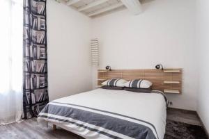 a bedroom with a bed with two pillows on it at Au repère d'Argante in Pézenas +34 photos