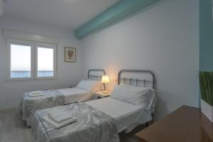 A bed or beds in a room at ATLANTICO Family Home by Cadiz4Rentals