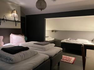 a bedroom with two beds and a mirror at Pajula B&B in Järvenpää