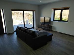a living room with a couch and a table at casa do mestre in Vieira do Minho