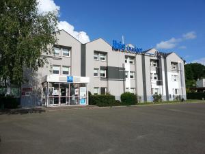 a large white building with a blue sign on it at ibis budget Chateaudun in Châteaudun