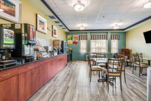 a restaurant with tables and chairs and a counter at Quality Inn Poughkeepsie in Poughkeepsie