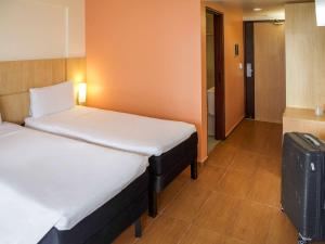 Postel nebo postele na pokoji v ubytování ibis Maceio Pajuçara