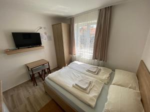 ein Schlafzimmer mit einem Bett mit zwei Handtüchern darauf in der Unterkunft Vila Zdravković Prolom Banja in Prolomska Banja