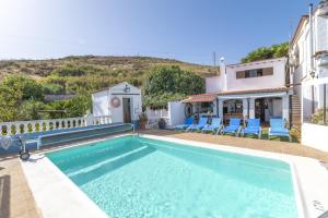 a villa with a swimming pool and a house at Casa Rosa with Heated Pool by I N Z U L A E in Vega de San Mateo