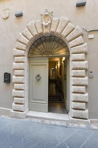 an archway entrance to a building with a door at Palazzo degli Stemmi in Todi