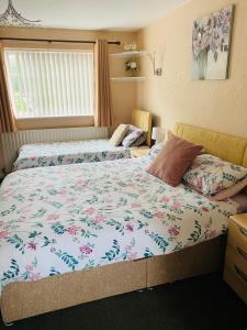 a bedroom with two beds and a window at The Mallards in Sleaford