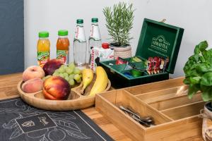 a wooden tray filled with fruit and bottles of juice at KP Claudia in Wieliczka