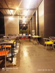 a dining room with tables and chairs and lights at StayBird - B Suite, Business Hotel, Kharadi in Pune