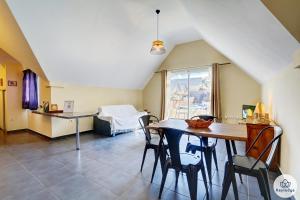 a kitchen and dining room with a table and chairs at T2 - Cantebazi 3 étoiles- plage de Saint-Leu in Saint-Leu