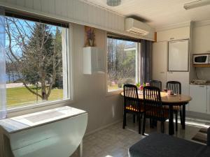 a kitchen and dining room with a table and a window at Viihtyisä kolmio järven rannalla in Haapavesi
